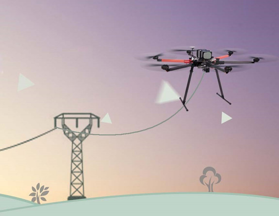 Drone deploying a guide line between transmission towers over mountainous terrain